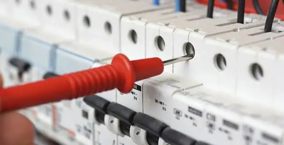 Electrical contractor testing circuit breakers during electrical repair in New Haven, IN
