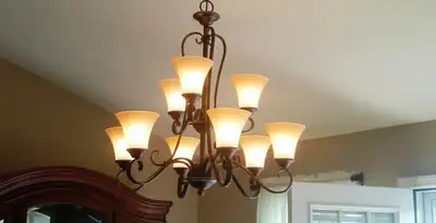 Classic ceiling chandelier installation with warm lighting in Fort Wayne, IN
