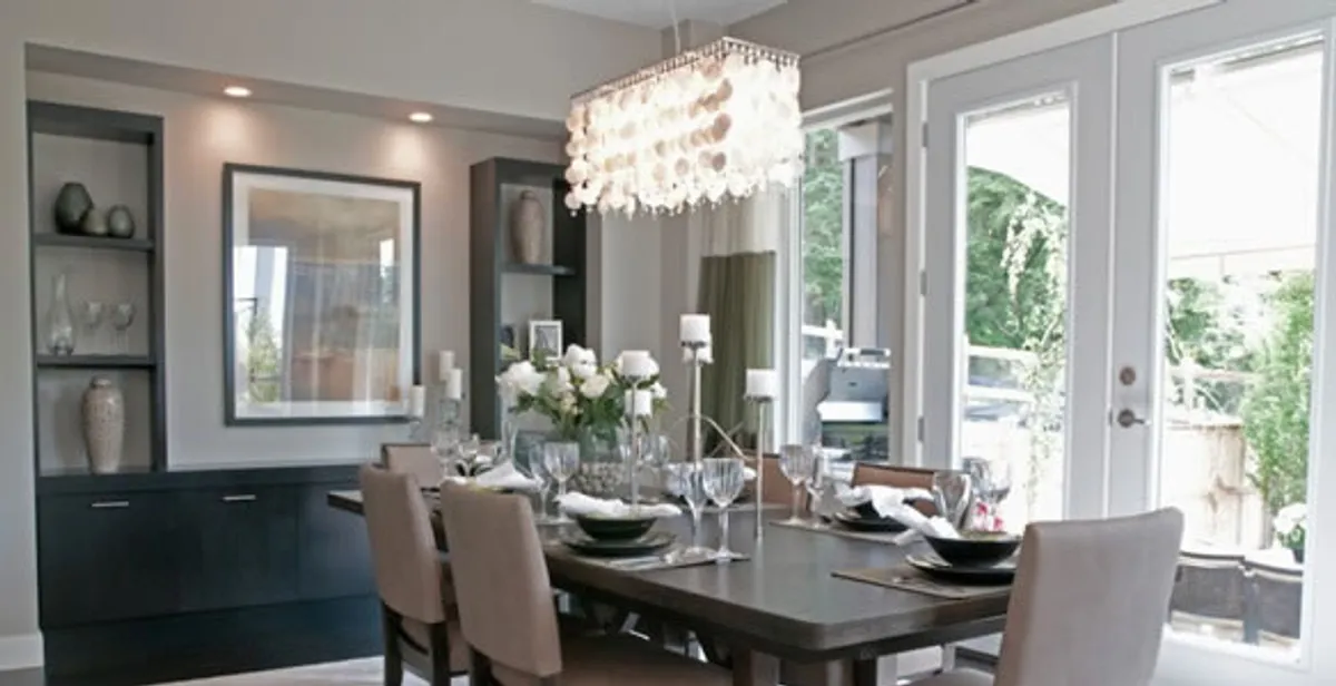 Elegant dining room chandelier installation above table in Fort Wayne, IN