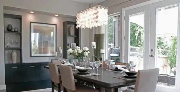 Elegant dining room chandelier installation above table in Fort Wayne, IN
