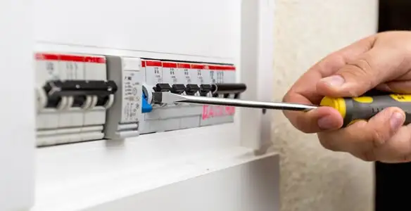 electrical panel upgrade service showing technician adjusting circuit breakers during system upgrade in Fort Wayne, IN