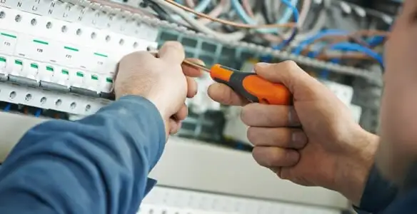 electrical service showing licensed electrician performing electrical panel maintenance and adjustments in Fort Wayne, IN