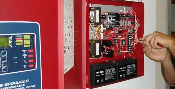 fire alarm installation service showing technician configuring fire alarm control panel in Fort Wayne, IN