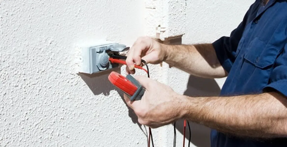 Electrician performing home electrical outlet and wiring inspection in Fort Wayne, IN