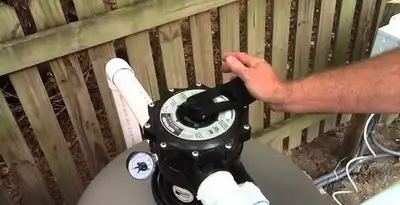 pool pumps service showing professional adjustment of pool pump control system in Fort Wayne, IN
